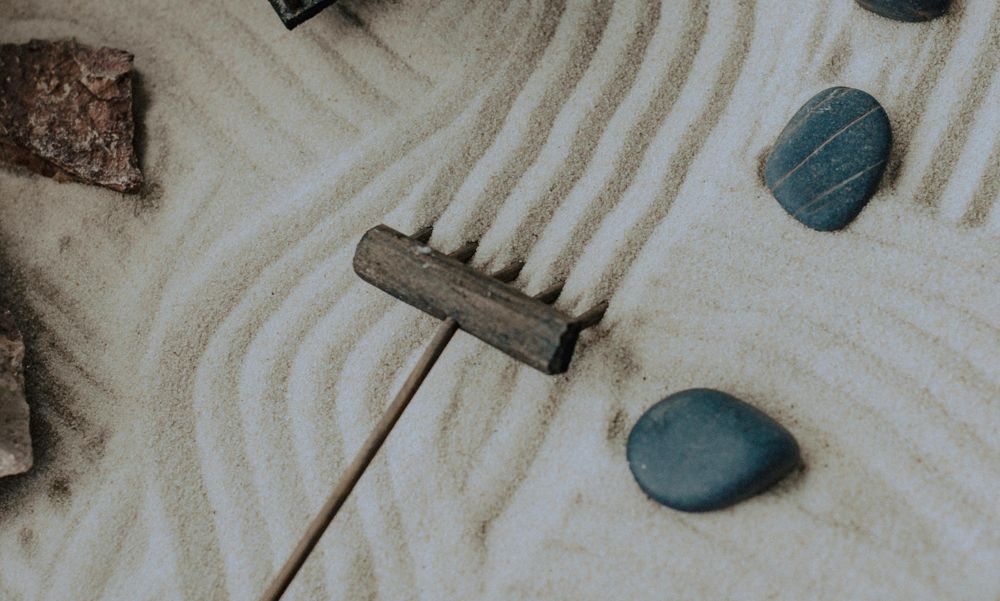 An image of a zen sand garden being raked.